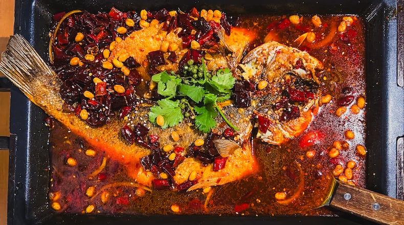 A dish at Jiang Nan described simply as grilled fish offers a spectacular whole fish, seen here swimming in Chongqing-style pepper sauce. (Henri Hollis/AJC)