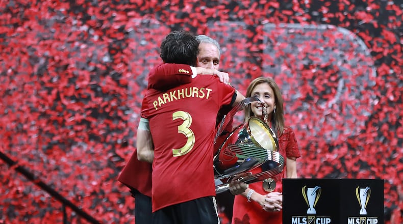 Dec 8, 2018 Atlanta: Atlanta United team captain Michael Parkhurst presents owner Arthur Blank the MLS CUP after a 2-0 victory over the Portland Timbers on Saturday, Dec 8, 2018, in Atlanta.   Curtis Compton/ccompton@ajc.com