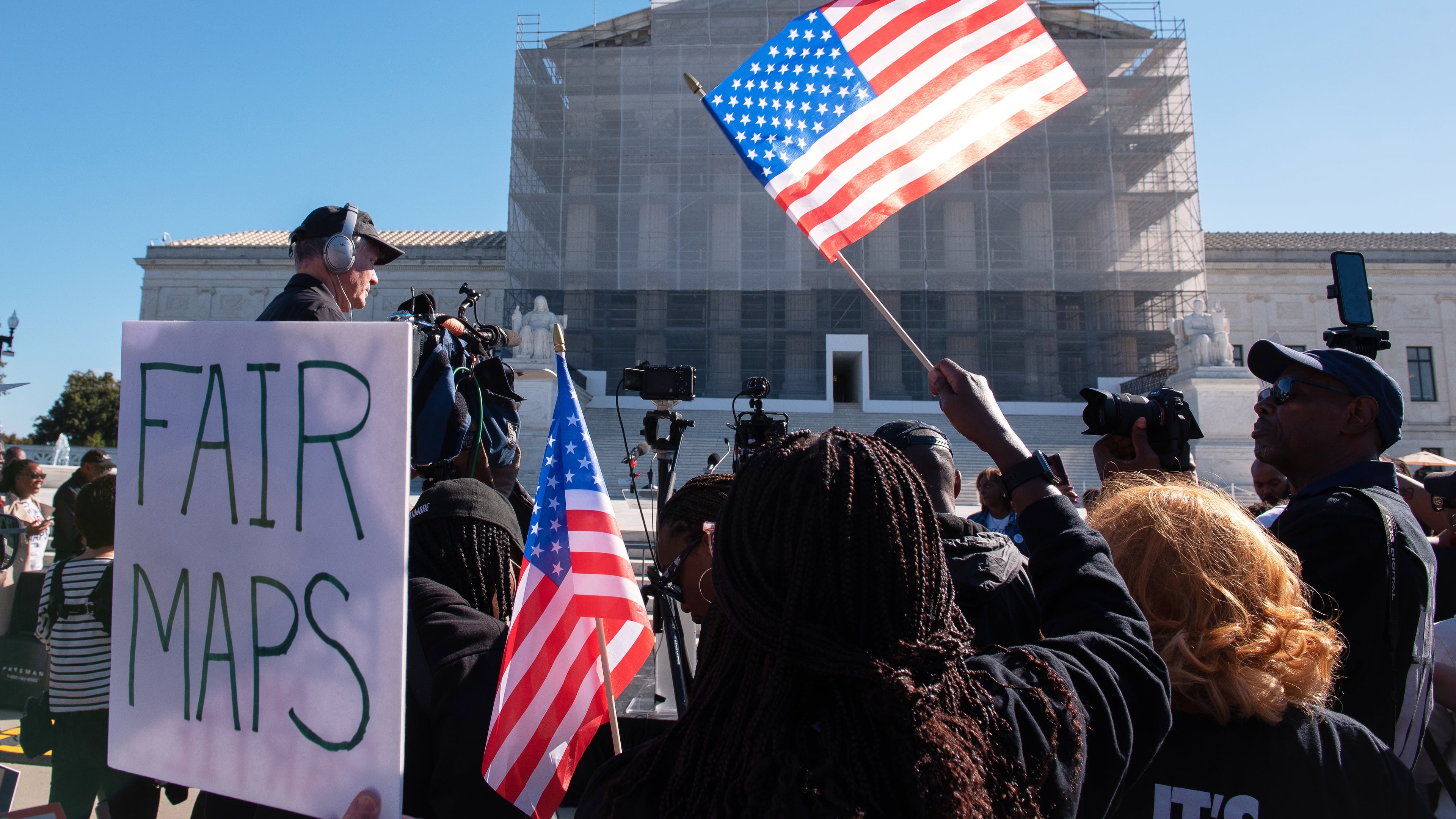 Voting rights activists gather outside the Supreme Court in Washington, early Wednesday, Oct. 15, 2025, as the justices prepare to take up a major Republican-led challenge to the Voting Rights Act, the centerpiece legislation of the Civil Rights Movement. (AP Photo/Cliff Owen)