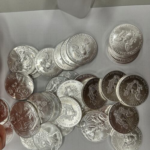 This handout photo released by Norwegian economic crime investigators on Thursday, Sept. 17, 2026, shows the U.S. "American Eagle" silver coins discovered by police in a van that was stopped after being driven "erratically" outside Oslo in April 2025. (Norwegian economic crime investigators via AP)
