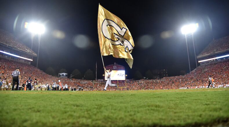 A Georgia Tech cheerleading team member runs with a  Tech flag before the second half at Memorial Stadium on the Clemson University campus in Clemson, S.C. on Thursday, August 29, 2019. Clemson won 52-14 over the Georgia Tech. (Hyosub Shin / Hyosub.Shin@ajc.com)