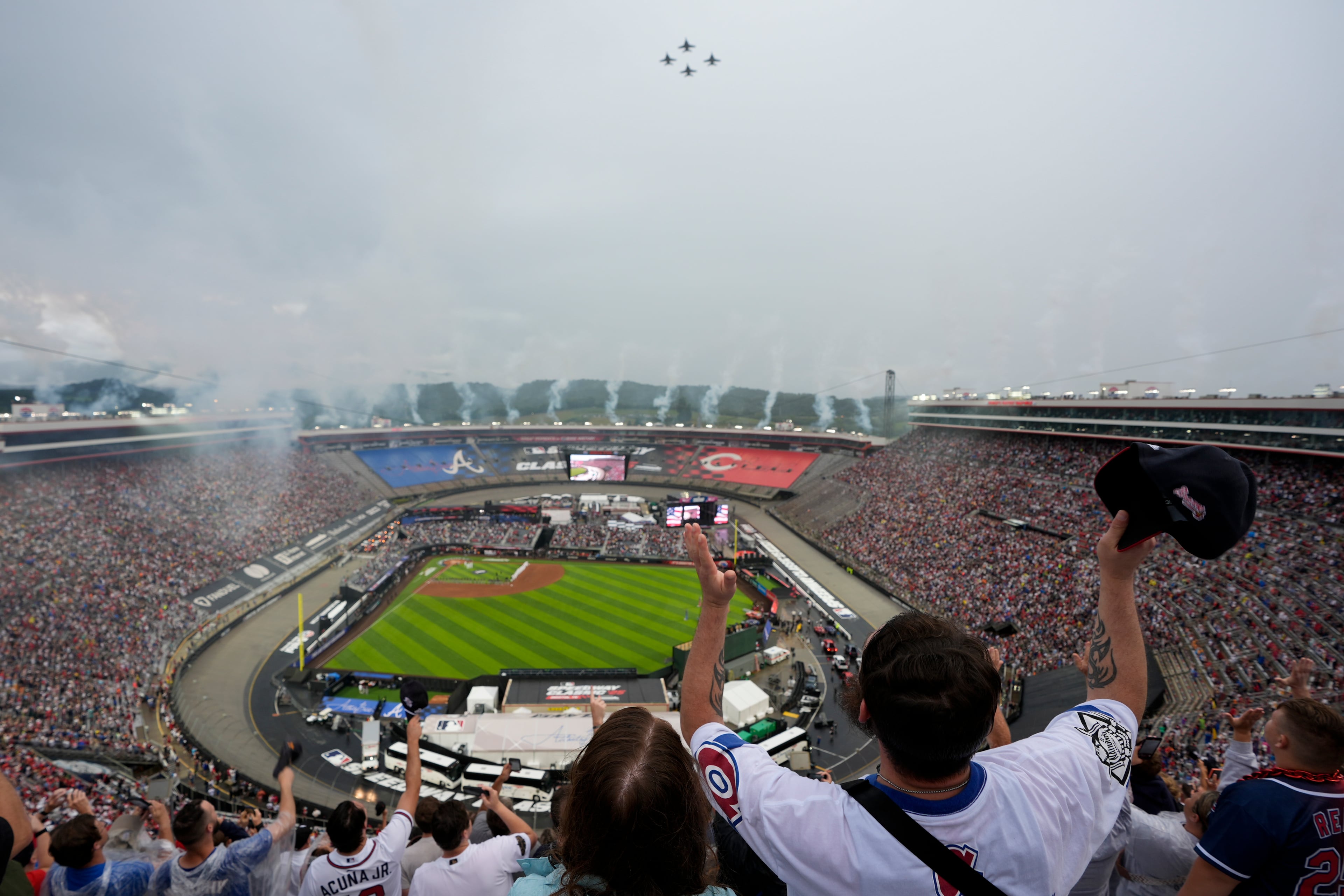 Fans cheer during a flyover before the MLB Speedway Classic baseball game between the Atlanta Braves and the Cincinnati Reds at Bristol Motor Speedway in Bristol, Tenn., Saturday, Aug. 2, 2025. (George Walker IV/AP)