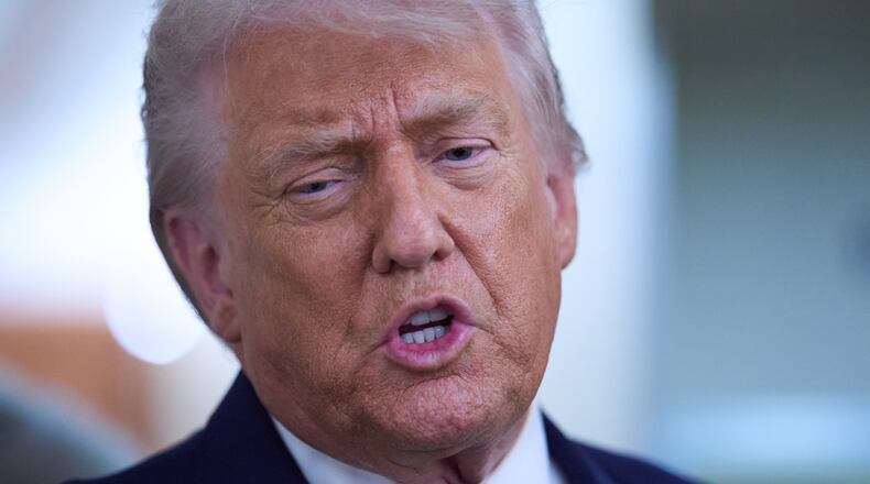 President Donald Trump speaks with reporters aboard Air Force One after leaving the World Economic Forum in Davos for Washington, Thursday, Jan. 22, 2026. (AP Photo/Evan Vucci)