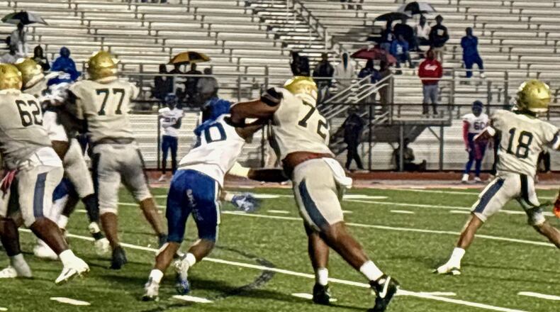 Hapeville Charter offensive lineman Chris Booker protects the pocket on a Hornets pass play against Washington on Oct. 9, 2025. Booker, who committed to Alabama in February, is the highest ranked offensive line prospect in Georgia. (Ken Sugiura/AJC)