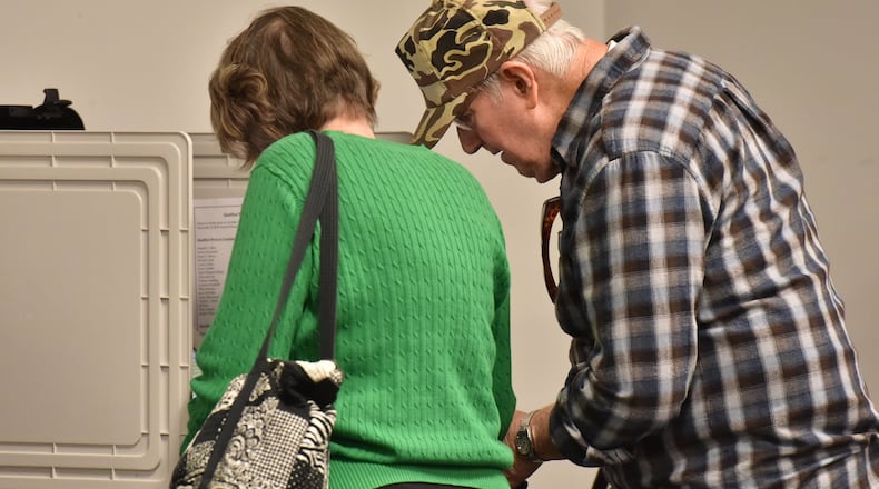 Early voters Roberta and Billy Howell, of Lawrenceville, cast their votes at Gwinnett County Board of Voter Registration and Elections in Lawrenceville on Wednesday, Oct. 26, 2016. HYOSUB SHIN / HSHIN@AJC.COM