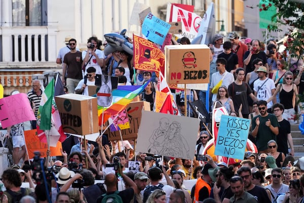 Activists stage a protest in Venice, Italy, Saturday, June 28, 2025, denouncing the three-day celebrations for the wedding between Jeff Bezos and his wife Lauren Sanchez Bezos that took place in Venice on Friday as a symbol of rising inequality and disregard for the city's residents. (AP Photo/Antonio Calanni)