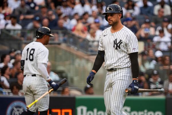 New York Yankees' J.C. Escarra walks back to the dugout after he struck out swinging during the seventh inning of a baseball game against the Milwaukee Brewers, Saturday, March 29, 2025, in New York. (AP Photo/Angelina Katsanis)