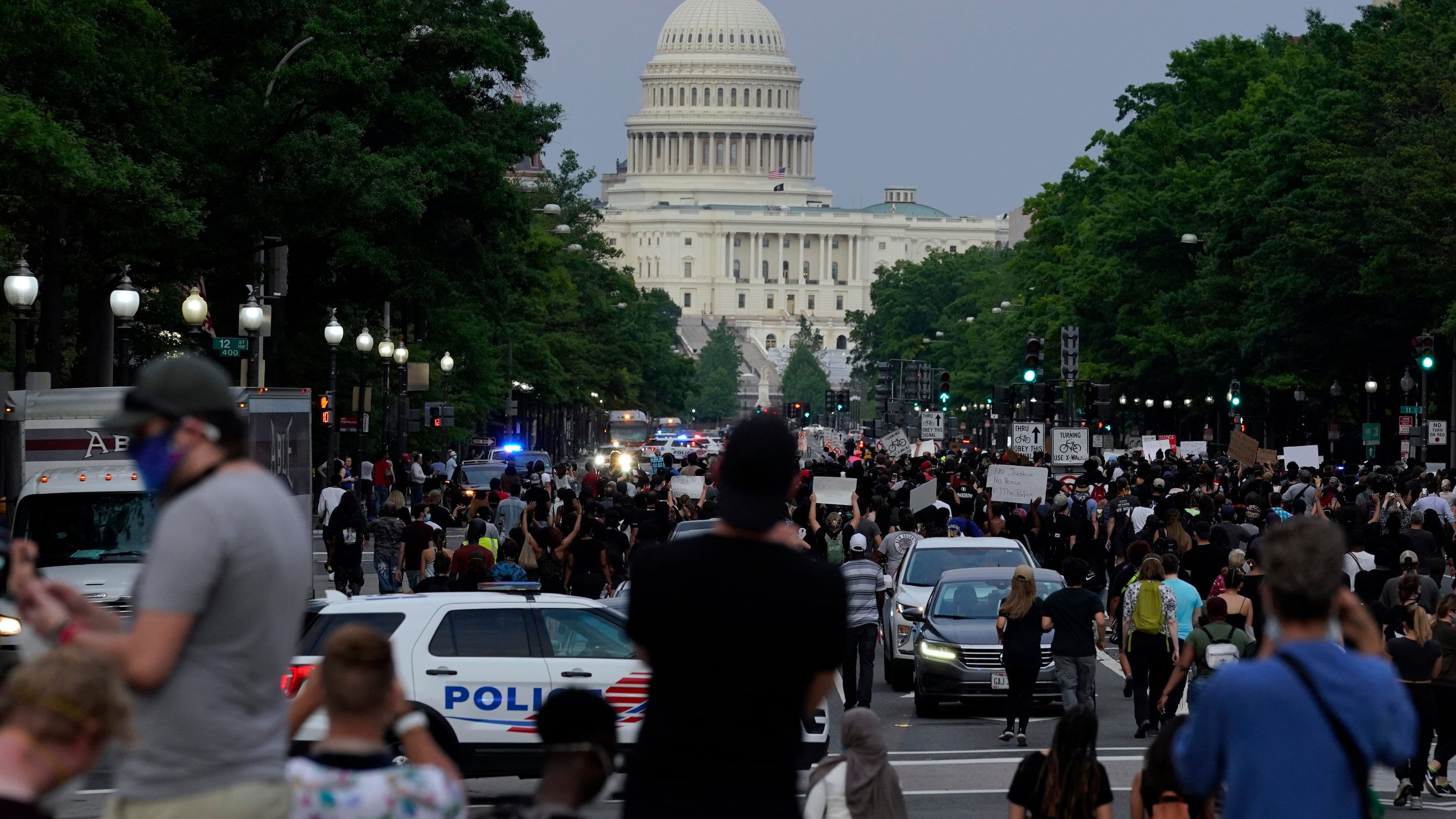 FILE - Demonstrators walk along Pennsylvania Avenue as they protest the death of George Floyd, May 29, 2020, in Washington. (AP Photo/Evan Vucci, File)
