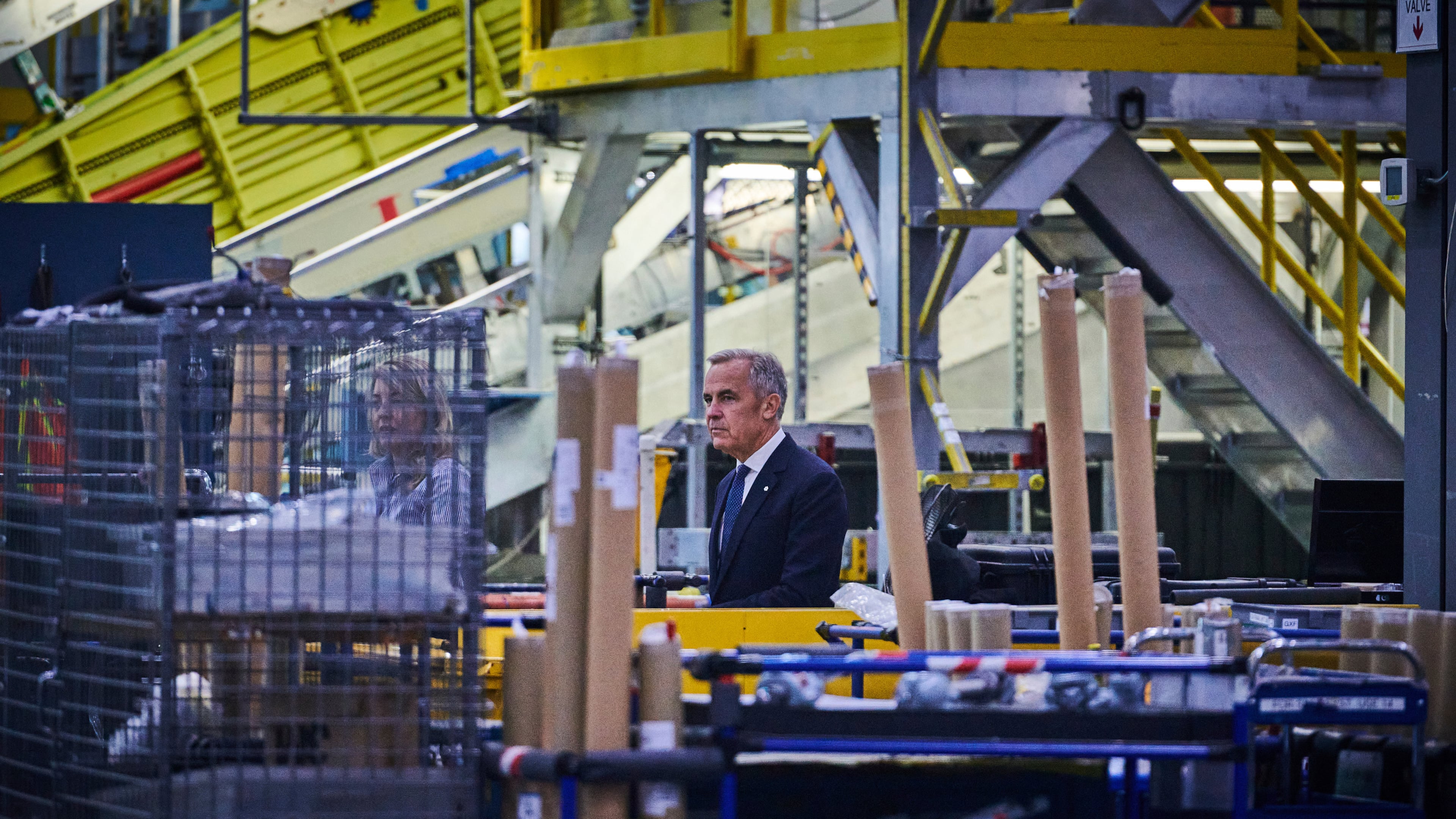 Prime Minister Mark Carney walks through a manufacturing facility ahead of a press conference in Mississauga, Ont., on Friday, Sept. 5, 2025. (Sammy Kogan /The Canadian Press via AP)