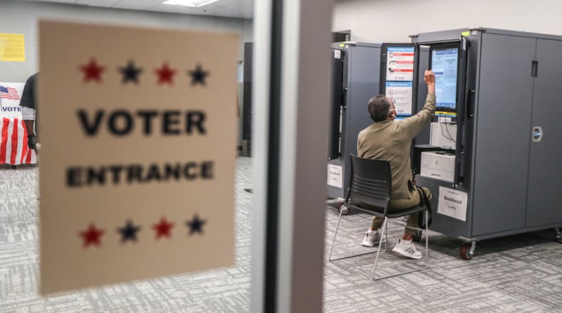 Pat Sims votes at the Buckhead Library on Oct. 12, 2021, as early voting locations opened across Georgia. Featuring the race for mayor of Atlanta and local contests statewide, the elections will be the first time many voters go to the polls since the General Assembly passed Georgia’s new voting law in March. Voters will decide on mayors, city councils, school boards and tax referendums. (John Spink / John.Spink@ajc.com)