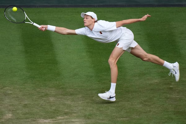 Jannik Sinner of Italy returns to Aleksandar Vukic of Australia during their second round men's singles match at the Wimbledon Tennis Championships in London, Thursday, July 3, 2025. (AP Photo/Alastair Grant)