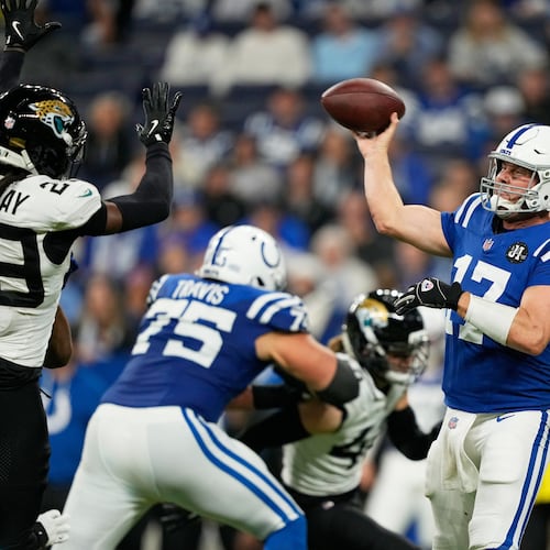 Indianapolis Colts quarterback Philip Rivers (17) throws under pressure from Jacksonville Jaguars safety Eric Murray (29) during the second half of an NFL football game Sunday, Dec. 28, 2025, in Indianapolis. (AP Photo/Carolyn Kaster)