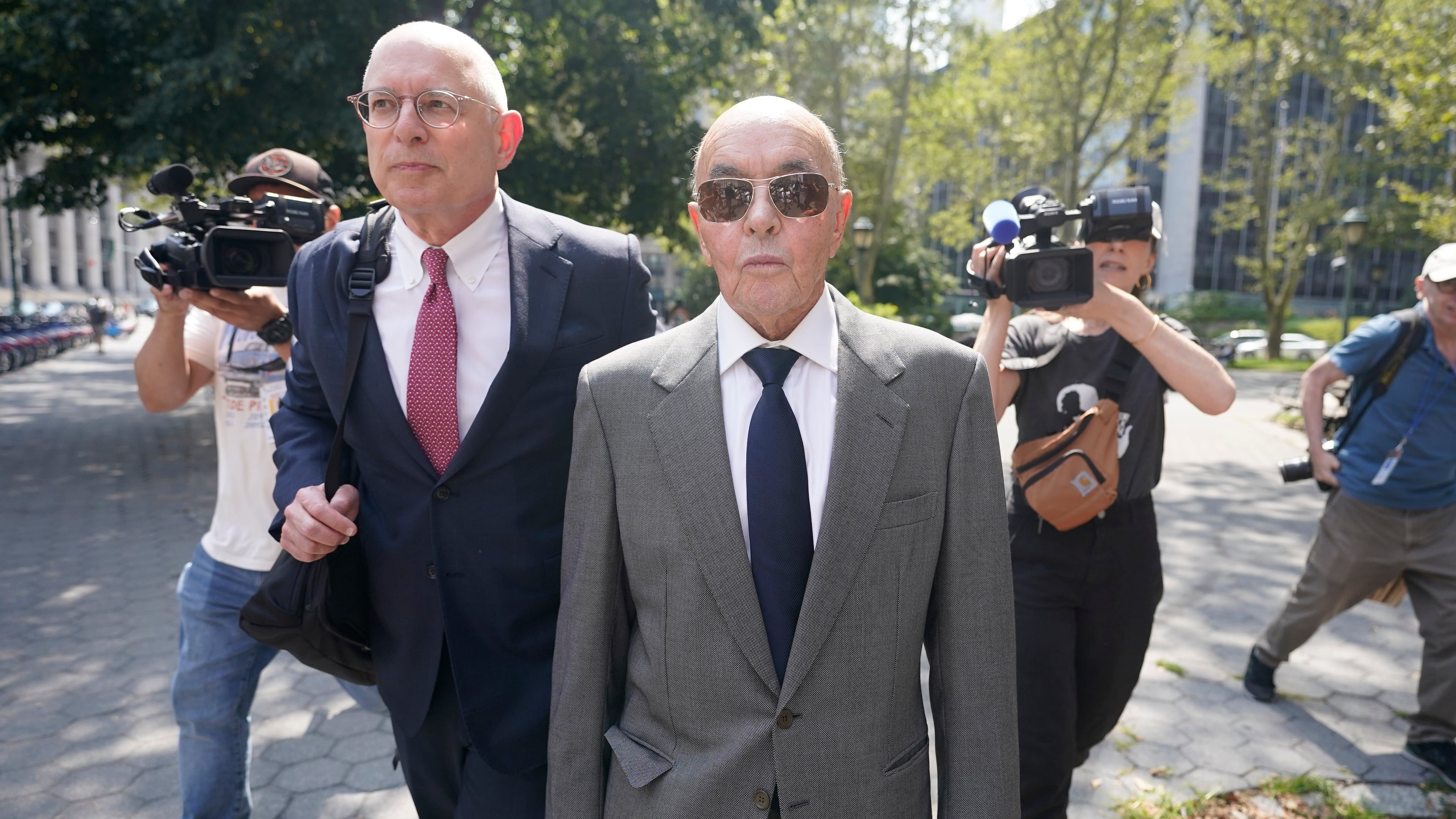 FILE - British billionaire Joe Lewis leaves, center, Manhattan federal court, July 26, 2023, in New York. (AP Photo/Mary Altaffer, File)