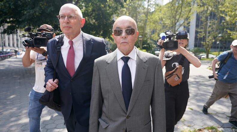 FILE - British billionaire Joe Lewis leaves, center, Manhattan federal court, July 26, 2023, in New York. (AP Photo/Mary Altaffer, File)
