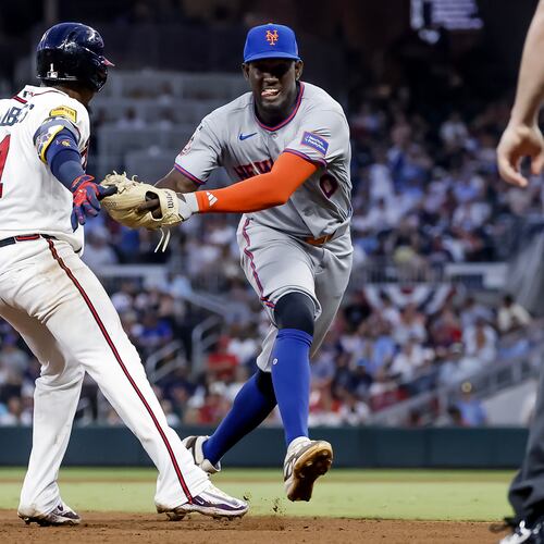New York Mets shortstop Ronny Mauricio, right, tags out Atlanta Braves' Ozzie Albies, left, between second base and third during the fifth inning of a baseball game, Monday, July 6, 2026, in Atlanta. (AP Photo/Erik S. Lesser)