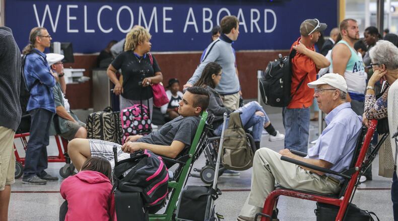 A longer-lasting computer outage last August led to more than 2,000 flight cancellations and days of disruption for fliers like these at Hartsfield-Jackson. JOHN SPINK /JSPINK@AJC.COM