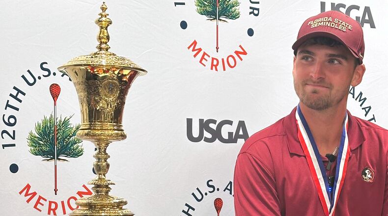 Jack Whaley admires his US Amateur golf championship trophy Sunday, Aug. 16, 2026, at Merion Golf Club in Ardmore, Pa. (AP Photo/Dan Gelston)