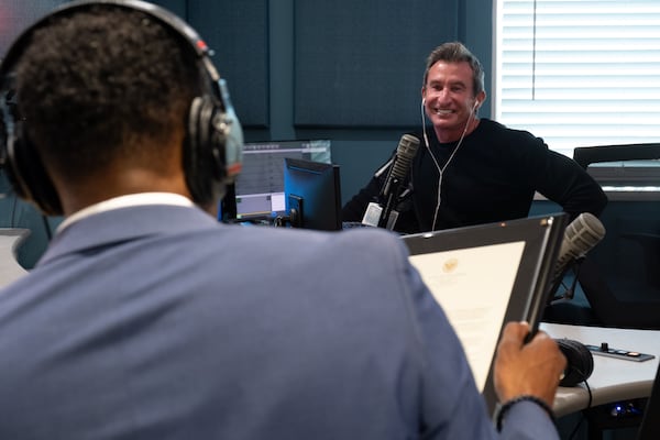 Atlanta Mayor Andre Dickens reads a letter to retiring radio personality Bert Weiss while recording a spot for the final “Bert Show” on Thursday, Oct. 23, 2025. (Ben Gray for the AJC)