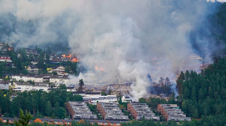 Smoke rises over terraced houses on fire in the Krokstadelva village in Drammen, Norway, Friday. July 17, 2026. (Thomas Fure/NTB Scanpix via AP)