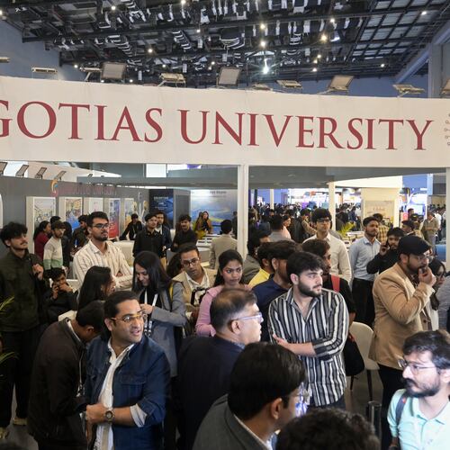 People visit Galgotias University stall at AI summit ahead of an eviction order issued by Indian authorities, in New Delhi, India, Wednesday, Feb. 18, 2026. (AP Photo)