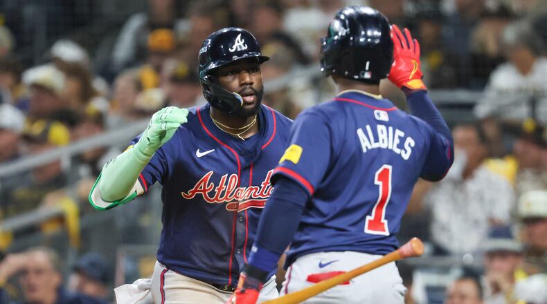 Atlanta Braves’ Michael Harris is greeted by Ozzie Albies (1) after a 2-RBI home run against the San Diego Padres during the eighth inning of National League Division Series Wild Card Game Two at Petco Park in San Diego on Wednesday, Oct. 2, 2024.   (Jason Getz / Jason.Getz@ajc.com)