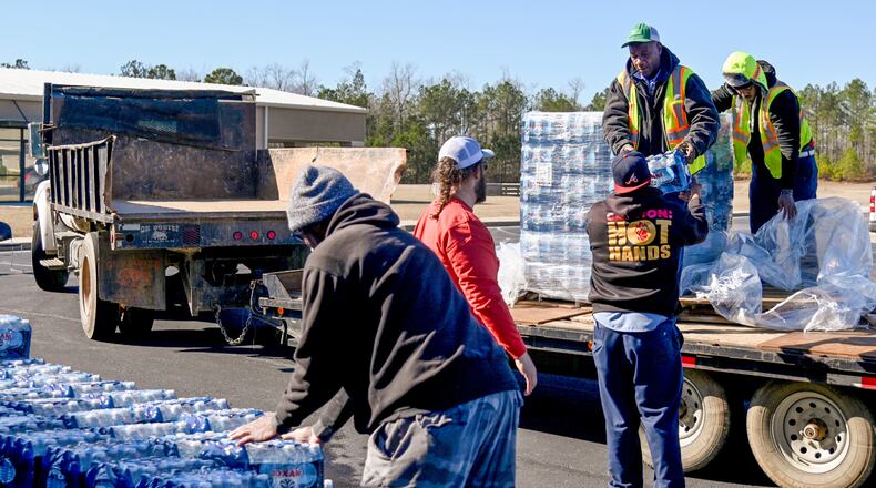 City workers unload water from the back of a truck bed at Northridge Christian Church in Milledgeville Tuesday afternoon. (Photo Courtesy of Jason Vorhees)