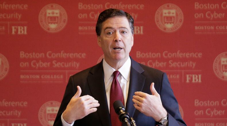 FILE - FBI Director James Comey gestures as he speaks on cyber security at the first Boston Conference of Cyber Security at Boston College, March 8, 2017, in Boston. (AP Photo/Stephan Savoia, File)