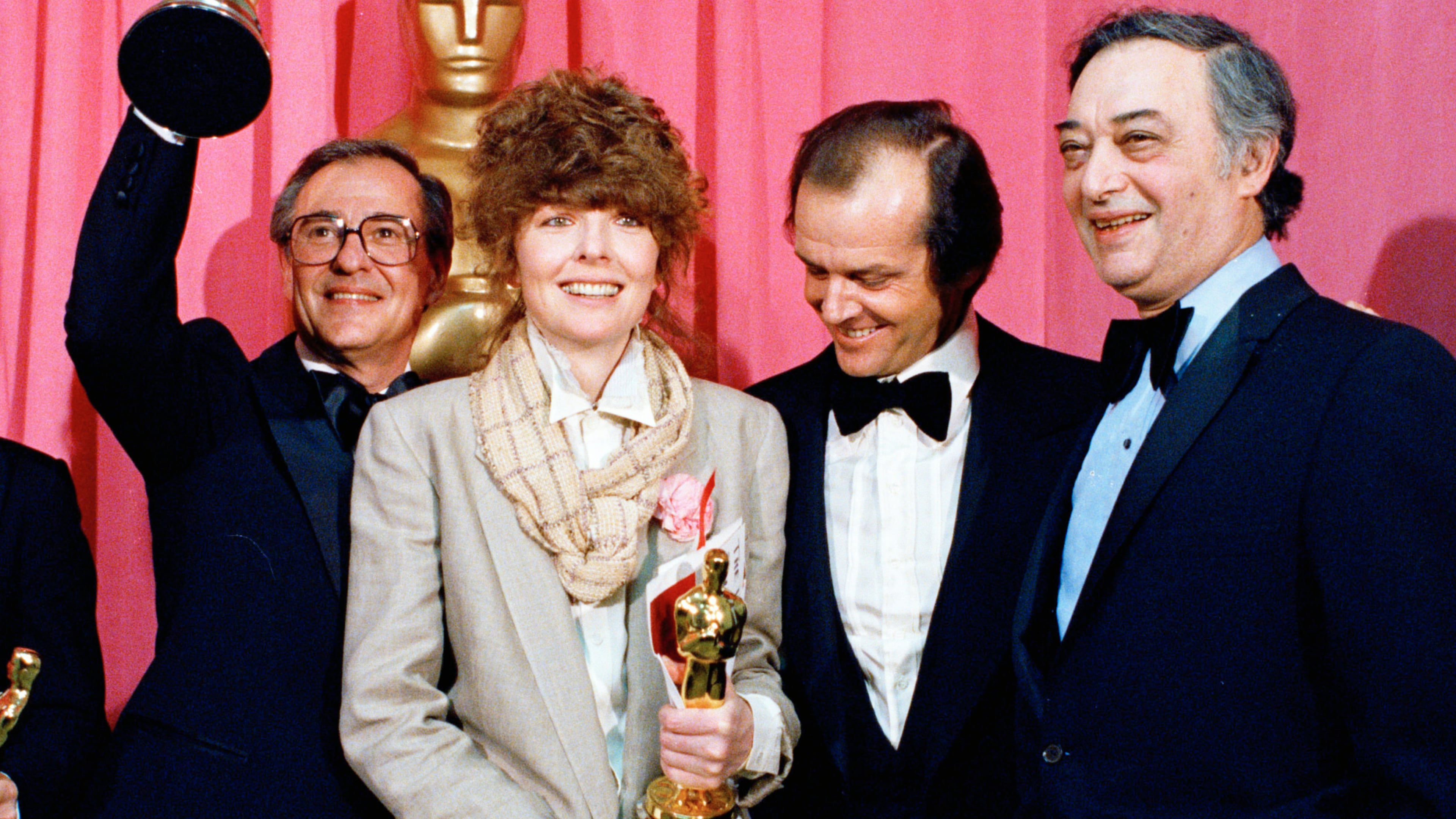 FILE - Oscar winners Charles H. Joffe, winner of best picture for "Annie Hall," left, and Diane Keaton, winner of best actress for "Annie Hall," poses with presenter Jack Nicholson, and producer Jack Rollins at the Academy Awards in Los Angeles on April 3, 1978. (AP Photo, File)