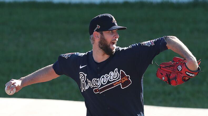 Braves pitcher Chris Martin delivers from the practice mounds during a morning session at spring training in CoolToday Park on Thursday, Feb. 25, 2021, in North Port, Fla. Curtis Compton / Curtis.Compton@ajc.com���