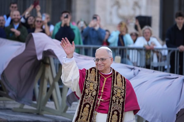 Pope Leo XIV waves upon his arrival at the Arch Basilica of St. John Lateran where he will presides over a Mass and takes possession of the Roman Cathedra, formalising his role as Bishop of Rome, in Rome, Sunday, May 25, 2025. (AP Photo/Andrew Medichini)