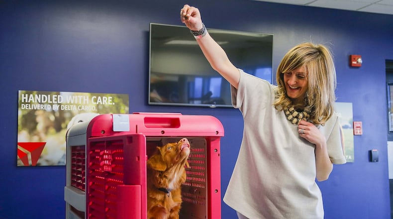Delta Cargo Lead Product Manager Sara Bernhardt and her 5-month-old Nova Scotia Duck Tolling Retriever, Peach, introduce the CarePod. (ALYSSA POINTER/ALYSSA.POINTER@AJC.COM)