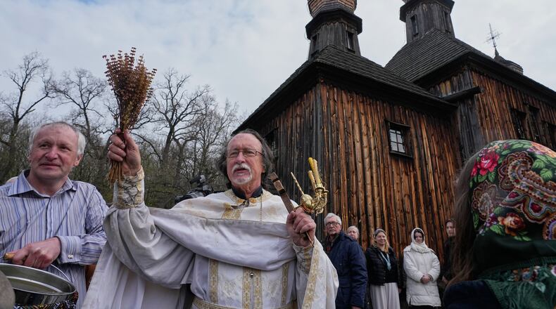 Priests bless believers and their Easter baskets to mark Orthodox Easter, in Pyrohiv, close to Kyiv, Ukraine, Sunday, April 12, 2026. (AP Photo/Efrem Lukatsky)
