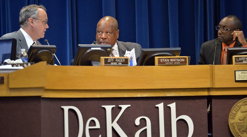 DeKalb County Commissioner Stan Watson (center) confers with Commissioner Jeff Rader (left) as Commissioner Larry Johnson looks on during a meeting at Aug. 26, 2014. HYOSUB SHIN / HSHIN@AJC.COM