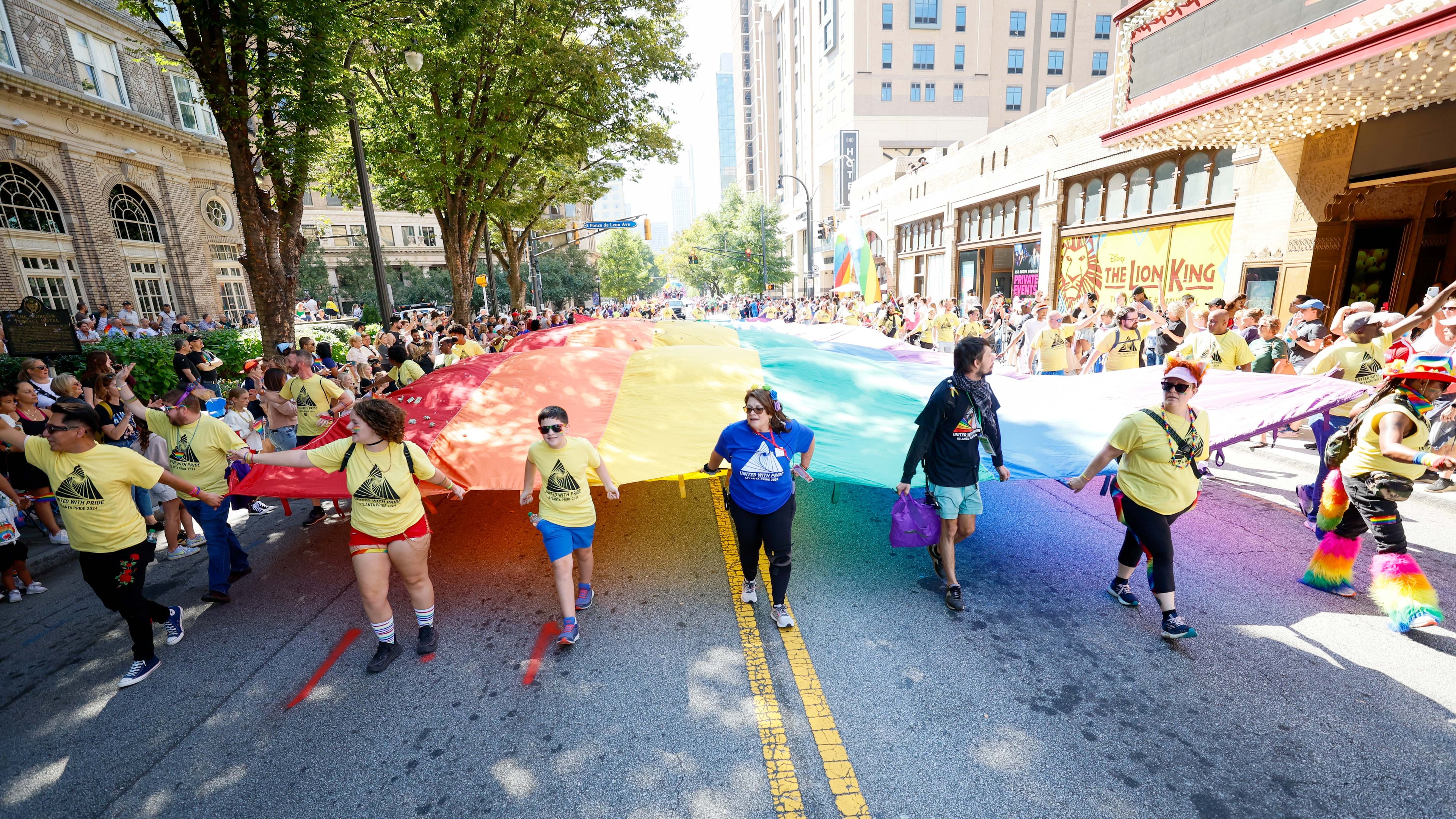 People carrying a giant pride flag participate in the annual Atlanta Pride Parade in 2024. (Miguel Martinez/AJC)