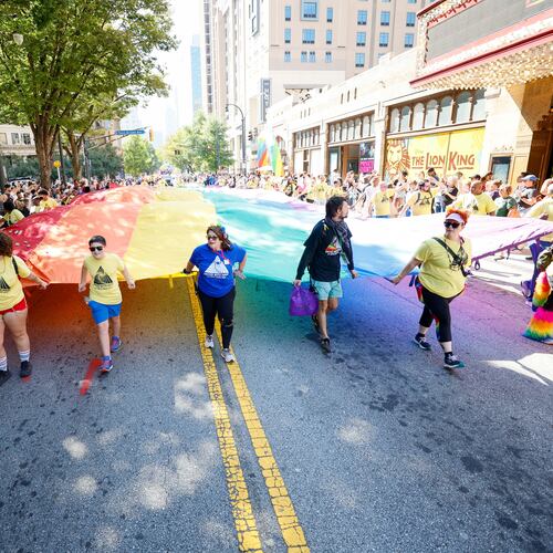 People carrying a giant pride flag participate in the annual Pride Parade in Atlanta on Sunday, Oct. 13, 2024. (Miguel Martinez/AJC)