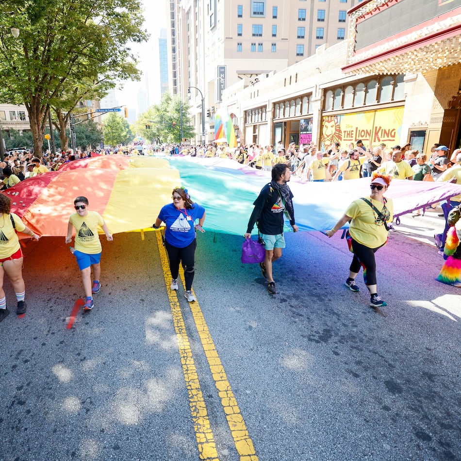 People carrying a giant pride flag participate in the annual Pride Parade in Atlanta on Sunday, Oct. 13, 2024. (Miguel Martinez/AJC)