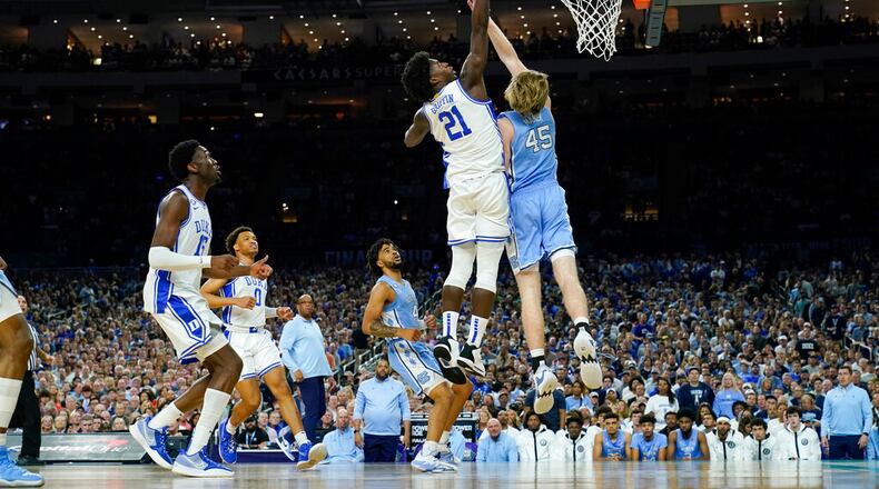 Duke's AJ Griffin (21) shoots over North Carolina's Brady Manek (45) during the first half of a college basketball game in the semifinal round of the Men's Final Four NCAA tournament, Saturday, April 2, 2022, in New Orleans. (AP Photo/David J. Phillip)