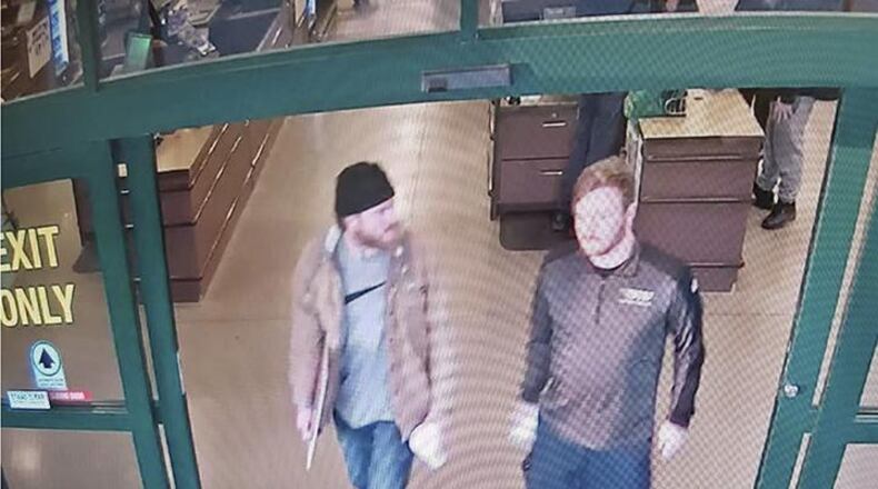 In this file image from a Jan. 1 surveillance video released by the U.S. Attorney's Office in Maryland, Brian Mark Lemley Jr., right, and Patrik Mathews leave a store in Delaware where they purchased ammunition and paper shooting targets. The pair, along with William Garfield Bilbrough IV, were arrested in January and are accused of plotting to commit violence at a Virginia gun rights rally.