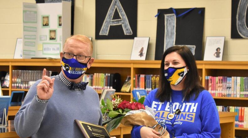 Cherokee County Superintendent of Schools Brian V. Hightower congratulates E.T. Booth Middle School media specialist Amanda Graves on earning the title of CCSD's 2021 Media Specialist of the Year.