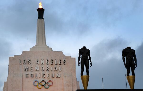 FILE - A blazing Olympic cauldron is seen at the Los Angeles Memorial Coliseum, Wednesday, Sept. 13, 2017. (AP Photo/Richard Vogel)