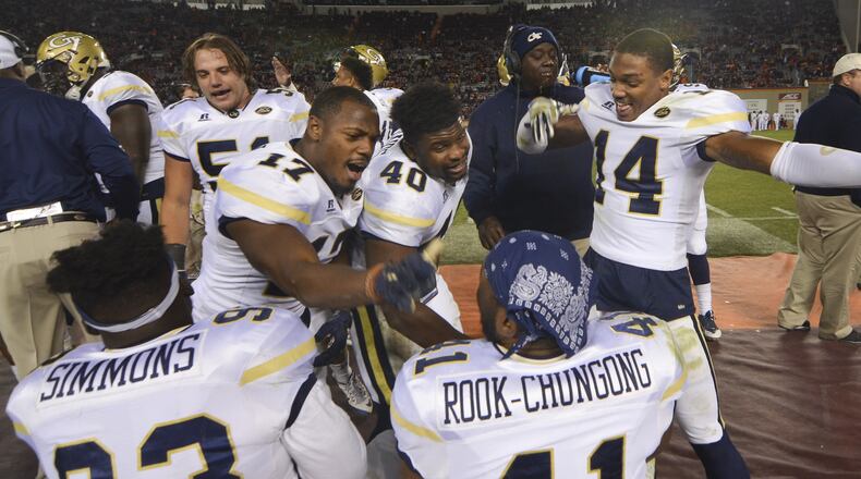 BLACKSBURG, VA - NOVEMBER 12: Defensive back Lance Austin #17, linebacker P.J. Davis #40, and defensive back Corey Griffin #14 of the Georgia Tech Yellow Jackets react with teammates defensive lineman Antonio Simmons #93 and defensive end Rod Rook-Chungong #41 in the second half against the Virginia Tech Hokies at Lane Stadium on November 12, 2016 in Blacksburg, Virginia. Georgia Tech defeated Virginia Tech 30-20. (Photo by Michael Shroyer/Getty Images)