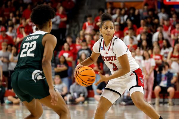 North Carolina State's Zamareya Jones (3) looks to pass the ball around Michigan State's Nyla Hampton (22) during the second half in the second round of the NCAA college basketball tournament in Raleigh, N.C., Monday, March 24, 2025. (AP Photo/Karl DeBlaker)