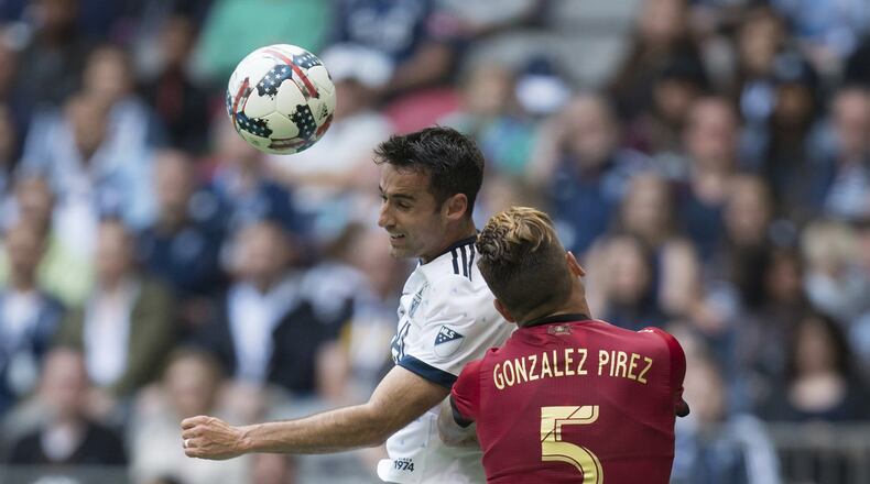 Vancouver Whitecaps’ Andrew Jacobson, left, and Atlanta United’s Leandro Gonzalez Pirez vie for the ball during their MLS soccer match Saturday, June 3, 2017, in Vancouver, British Columbia. (Darryl Dyck/The Canadian Press via AP)