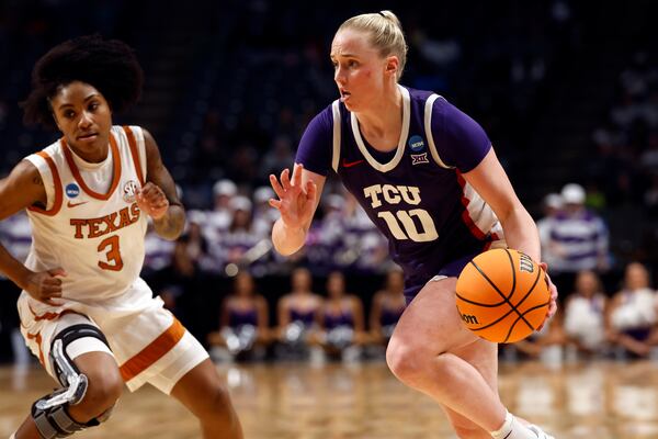 TCU guard Hailey Van Lith (10) drives to the basket around Texas guard Rori Harmon (3) during the first half in the Elite Eight of the NCAA college basketball tournament, Monday, March 31, 2025, in Birmingham, Ala. (AP Photo/Butch Dill)