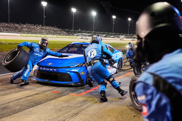 The pit crew for Denny Hamlin works on the car during a pit stop in a NASCAR Cup Series auto race Sunday, June 1, 2025, in Lebanon, Tenn. (AP Photo/George Walker IV)