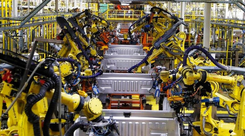 Robots weld the bed of Ford F Series trucks on the assembly line at the Ford Rouge assembly plant in Dearborn, Mich. (AP Photo/Carlos Osorio 2018)