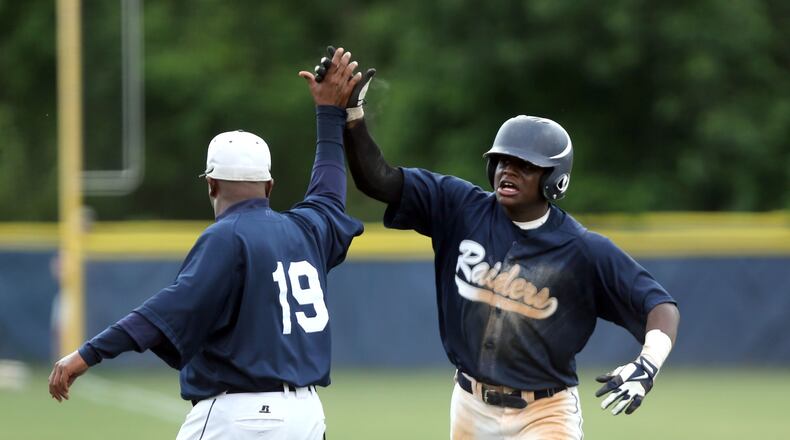 Redan's Miles Fore, right, celebrates his two-run home run with coach Marvin Pruitt in the 7th inning of the first game in the Class AAAA state final series in June, 2020, in Atlanta. (Jason Getz / AJC)