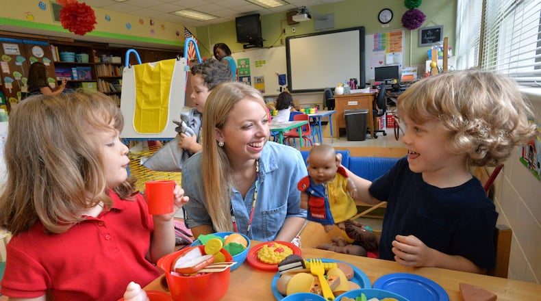 September 10, 2014 Atlanta - Pre-Kindergarten teacher Erin Augustine (center) works with her students Savannah Thelen (left), 4, and Kingston Rogers, 4, at Montgomery Elementary School on Wednesday, September 10, 2014. Education has emerged as one of the key issues in the gubernatorial race, with both candidates promising changes aimed at improving student achievement. Among the education topics being debated is Pre-Kindergarten. HYOSUB SHIN / HSHIN@AJC.COM There is a debate underway among parents about when children should start "academic" school. and whether preschool is too soon. A new study will likely add to the debate. HYOSUB SHIN / HSHIN@AJC.COM