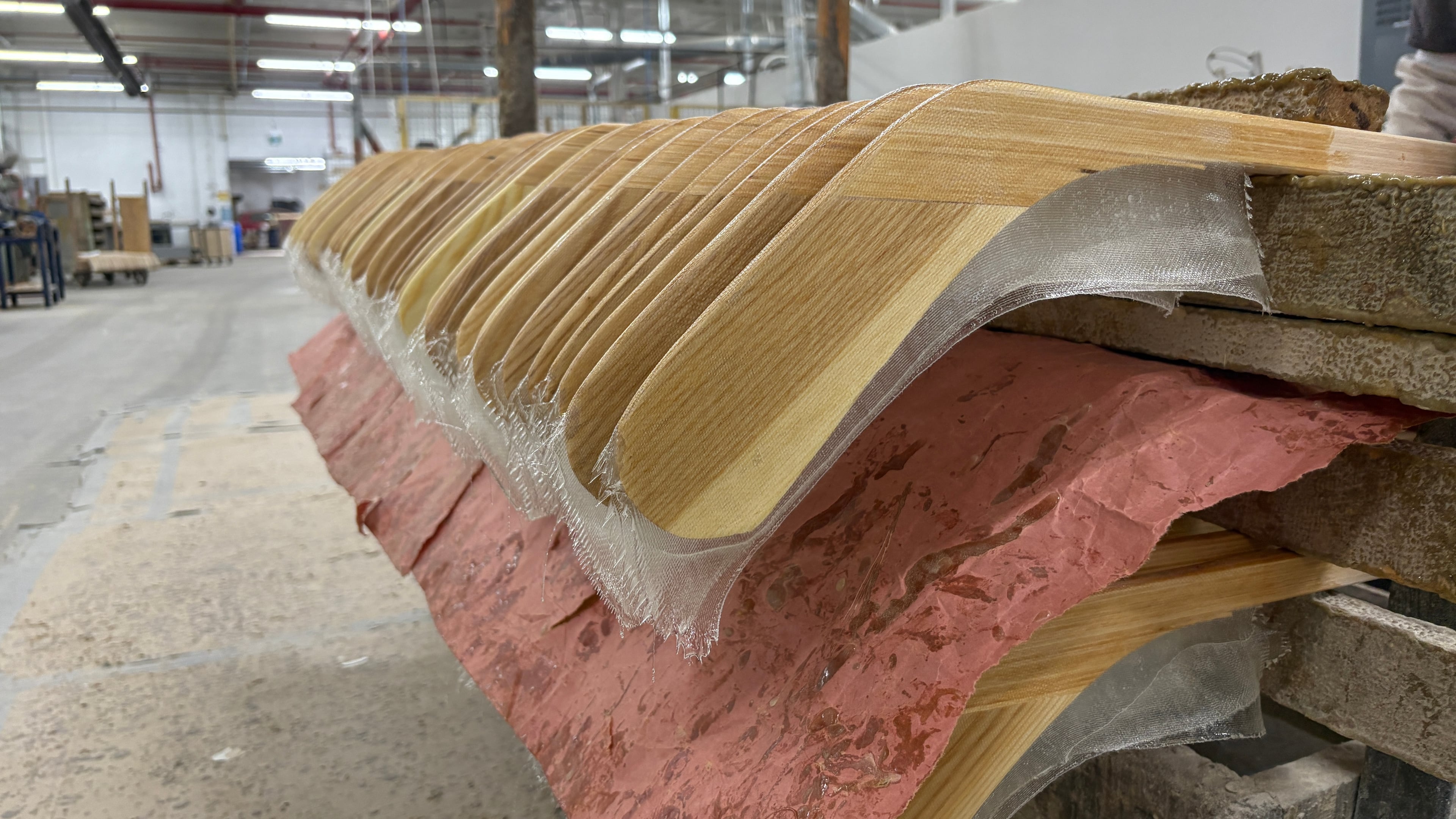 Wooden hockey sticks are stacked as they move along the assembly line at the Roustan Hockey factory, which is the last major manufacturer of hockey sticks in Canada on Aug. 27, 2025 in Brantford, Ontario. (AP Photo/Kelvin Chan)