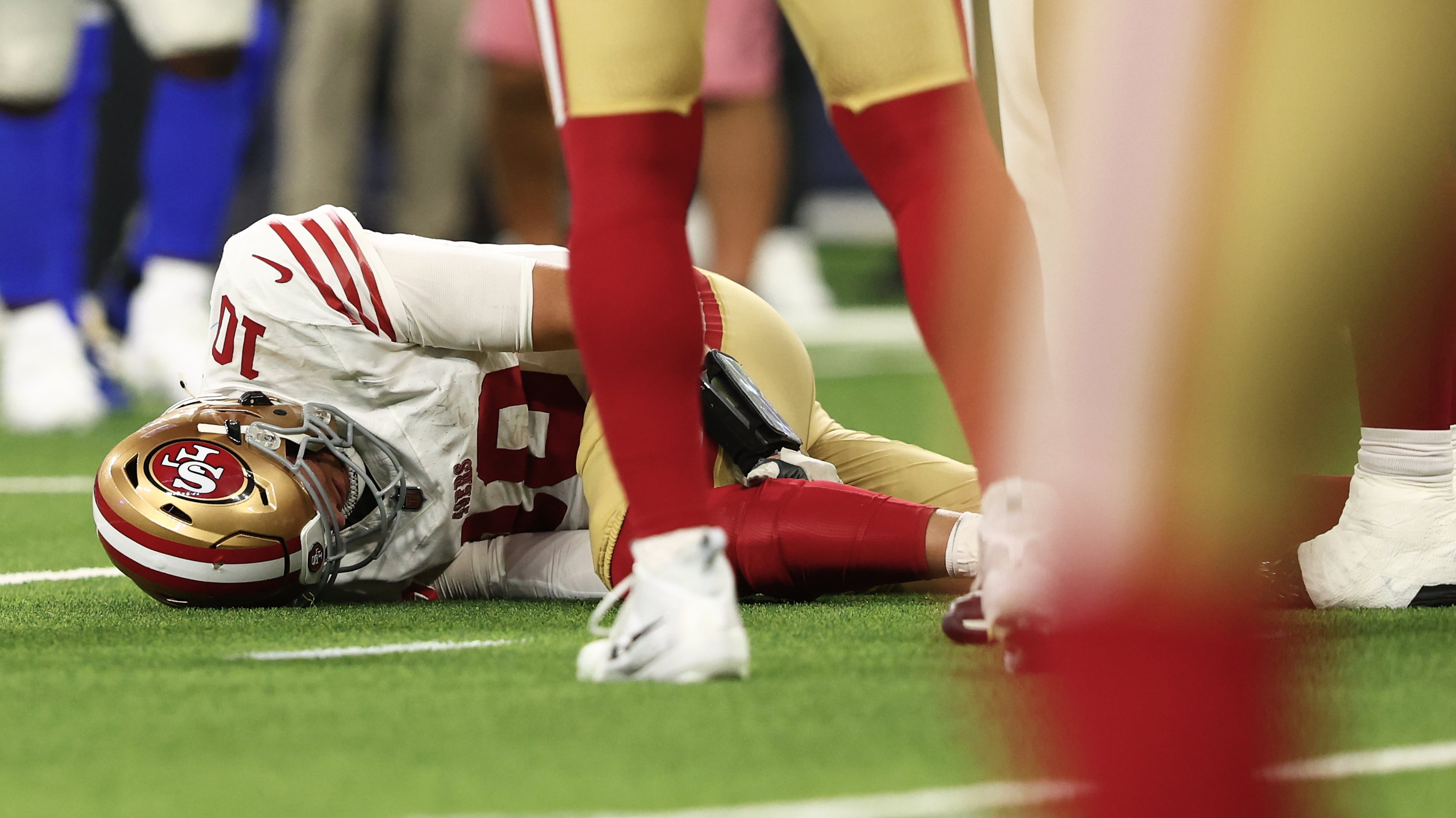 San Francisco 49ers quarterback Mac Jones remains on the ground after a play during the second half of an NFL football game against the Los Angeles Rams, Thursday, Oct. 2, 2025, in Inglewood, Calif. (AP Photo/Jessie Alcheh)